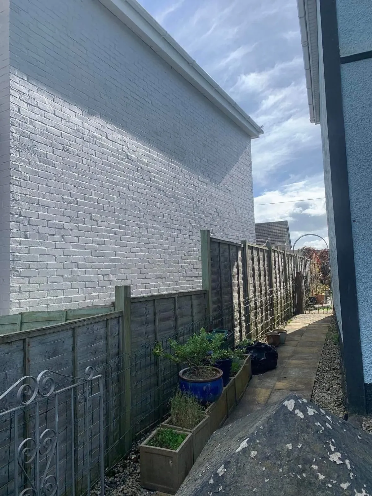 Freshly painted brick wall after preparation and masonry paint in Mullion